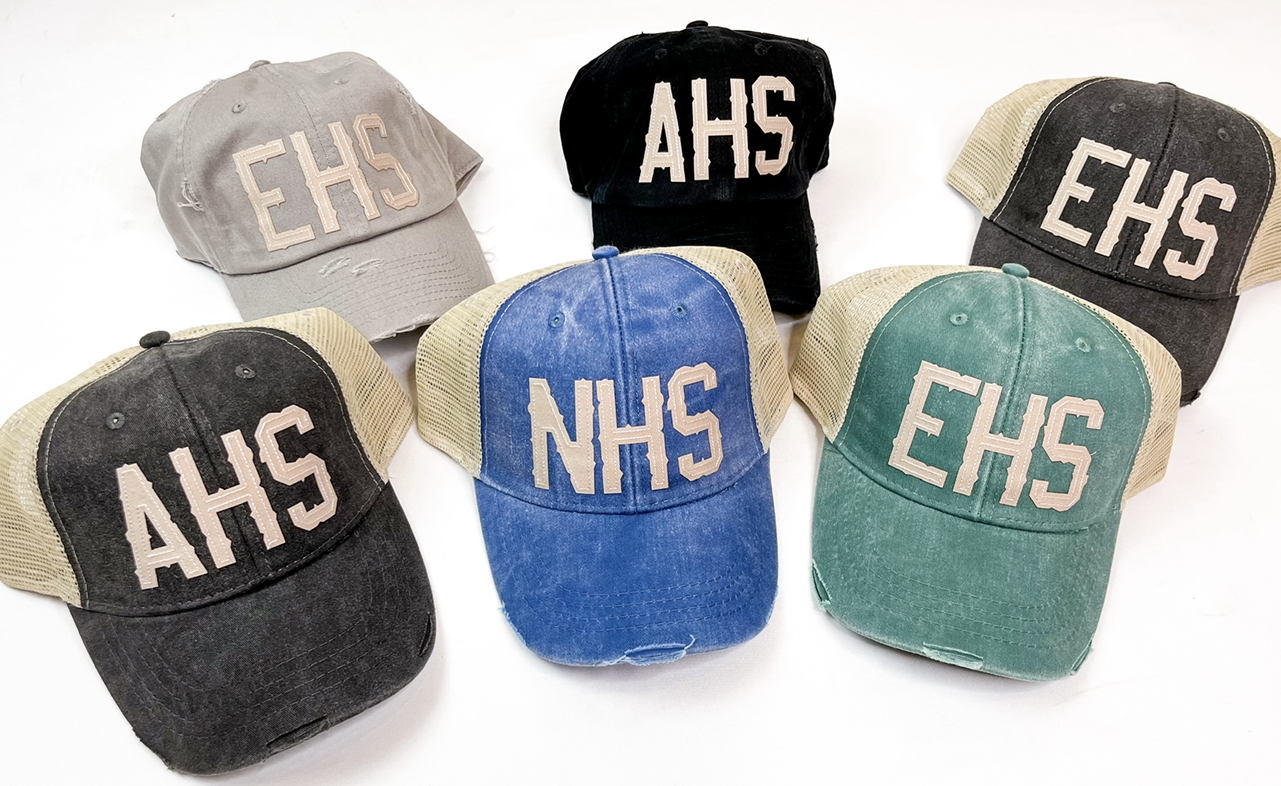 Back to Front L-R: Light Gray Solid, Black Solid, Black Trucker, Black Trucker, Royal Trucker, Green Trucker